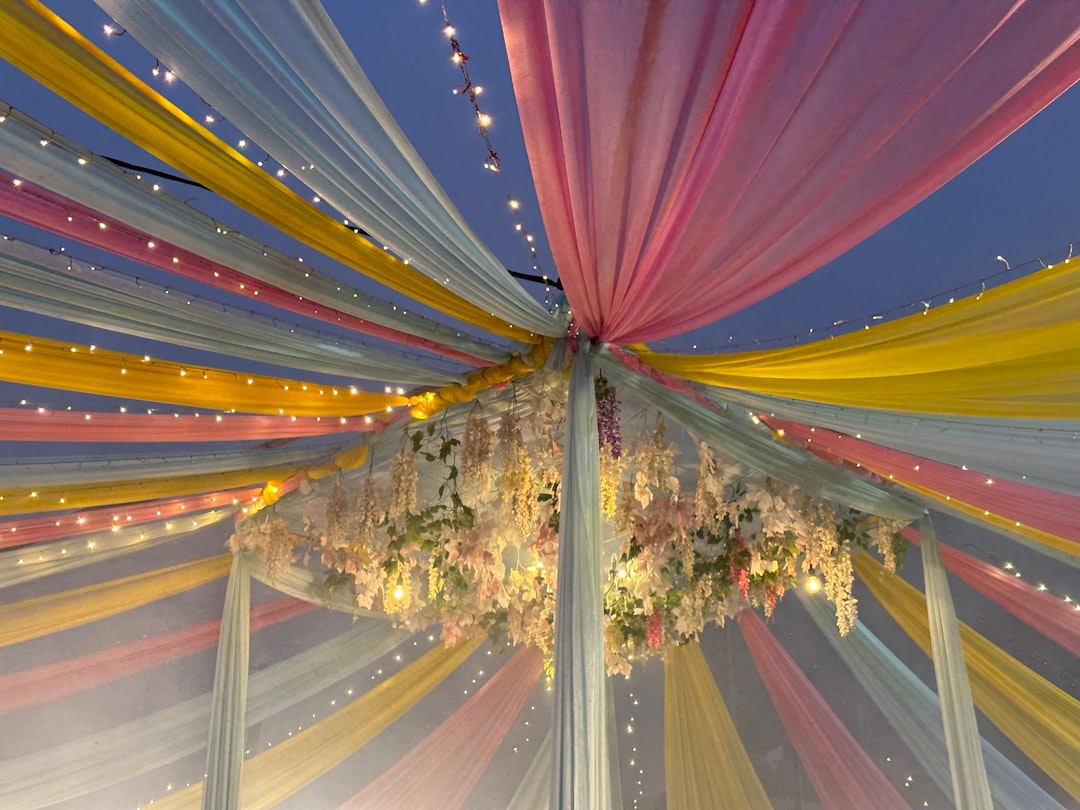 our-story-02 a-canopy-covered-in-colorful-fabric-and-flowers-9we2sf7xum8